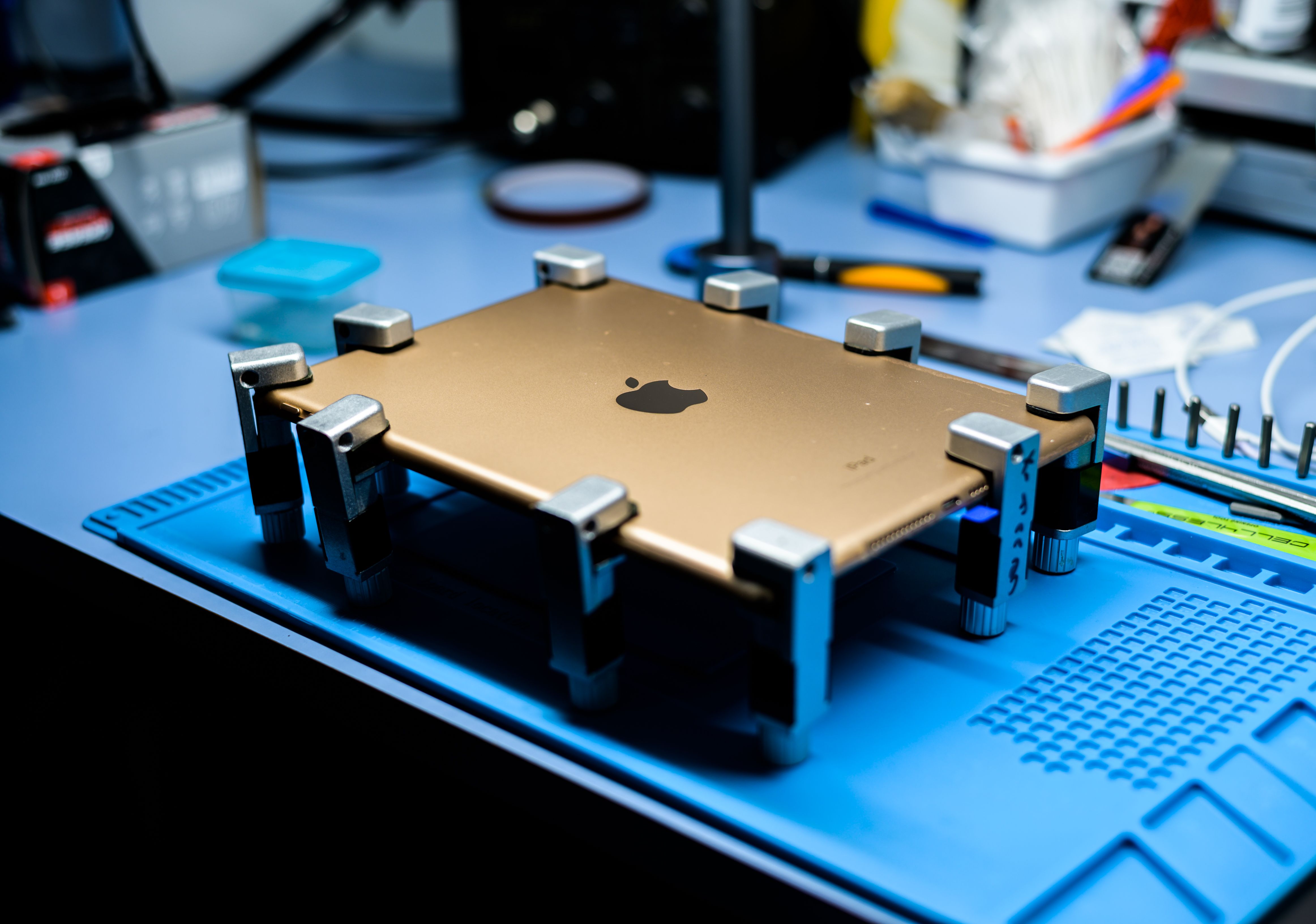 Tablet being repaired on a technician workbench